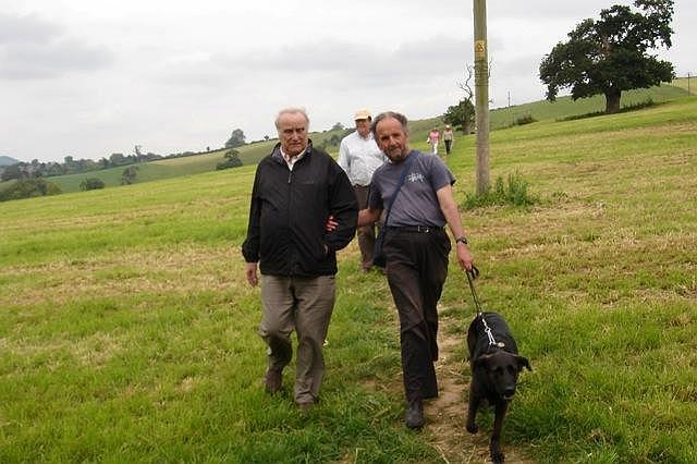 Clive Lewis-Hopkins with Peter Liesching and Meg his guide dog for the blind. Behind is Peter Isaac and in the distance Diana Lutley and Gail Isaac